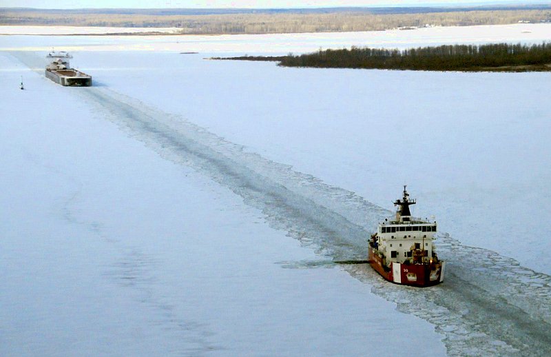The Mackinaw breaking a path for a downbound merchant vessel in Munuscong Bay on the St. Mary's River in December 2013. Photo courtesy of U.S. Coast Guard Air Station Traverse City.